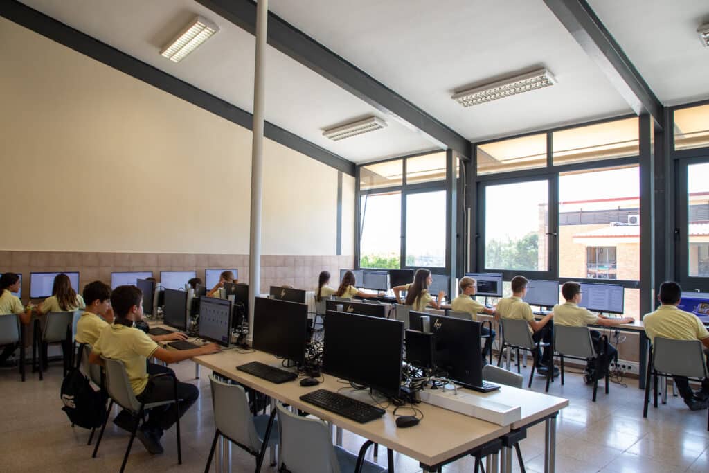 a group of people in a room with computers